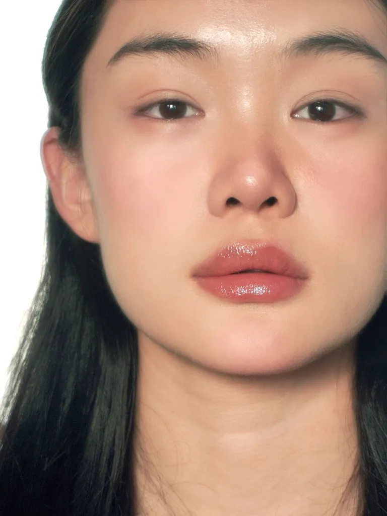 Sober — glossy lips, calm presence, no filter